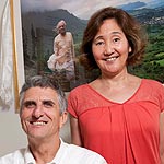 Ray Madigan and Shelley Choy in front of a picture of BKS Iyengar
